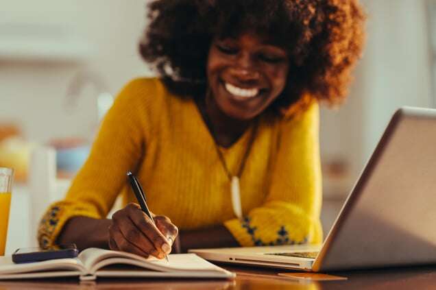 close-up-of-a-happy-casual-businesswoman-writing-d-2023-07-11-07-20-16-utc